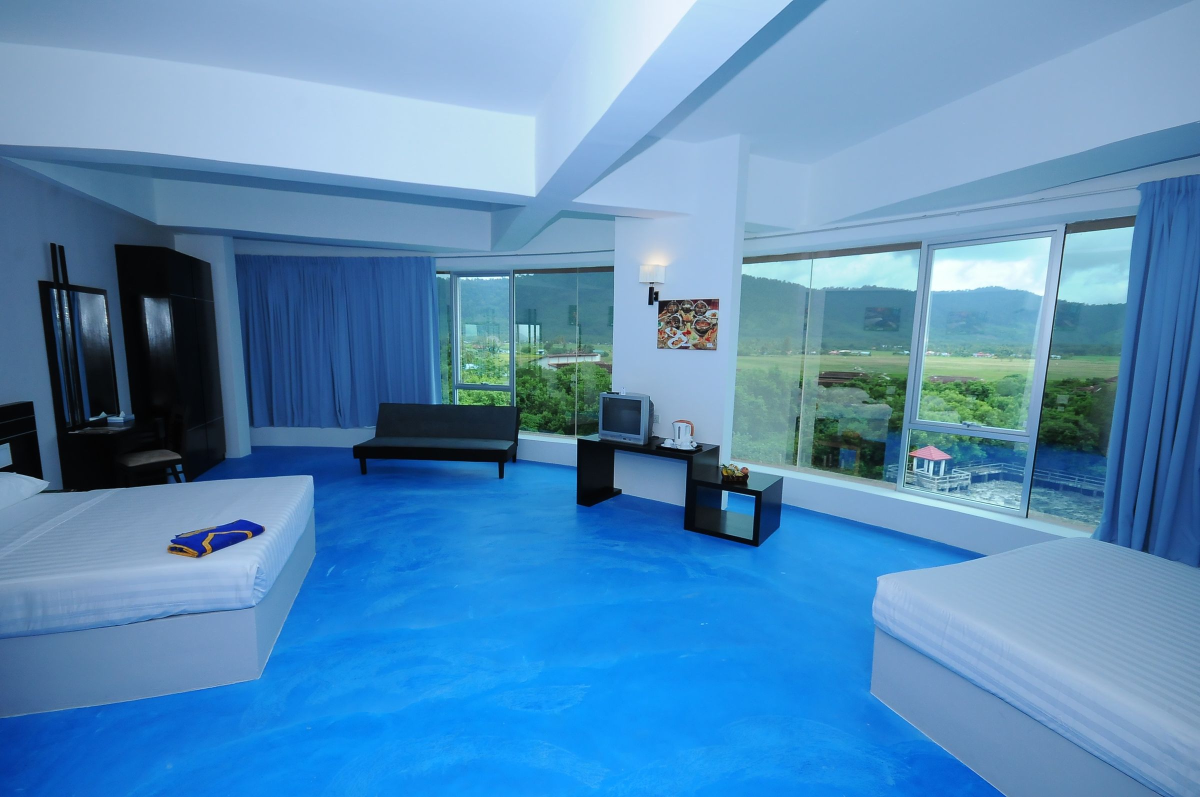 Family room with panoramic windows and hill views